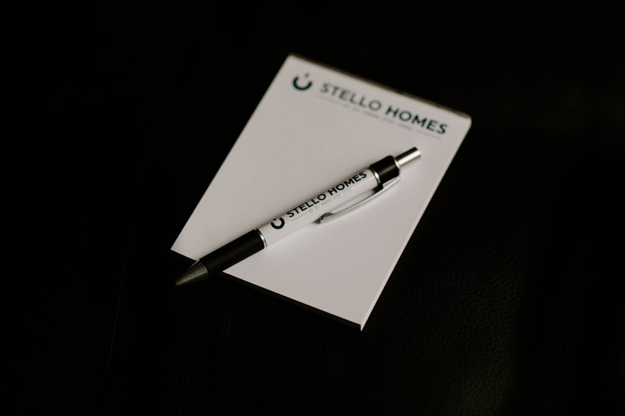 Stello Homes Real Estate Agent - Join Us Notepad and Pen